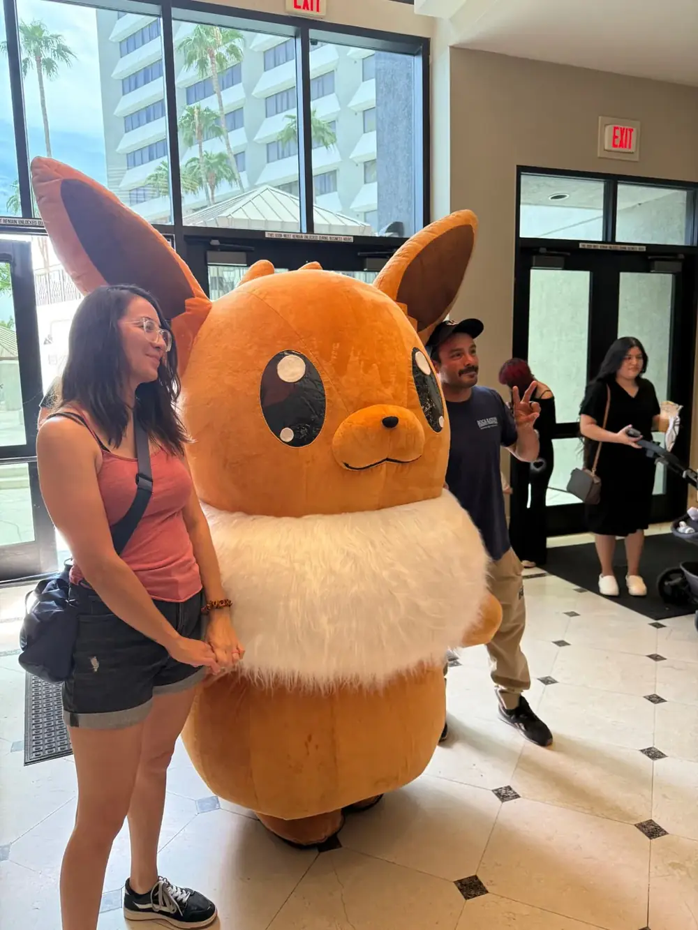 Eevee cosplayer meet & greet at The Cactus TCG Show Attendee meeting the life-size Eevee cosplayer in the lobby at The Cactus TCG Show Pokémon card show in Mesa, Arizona