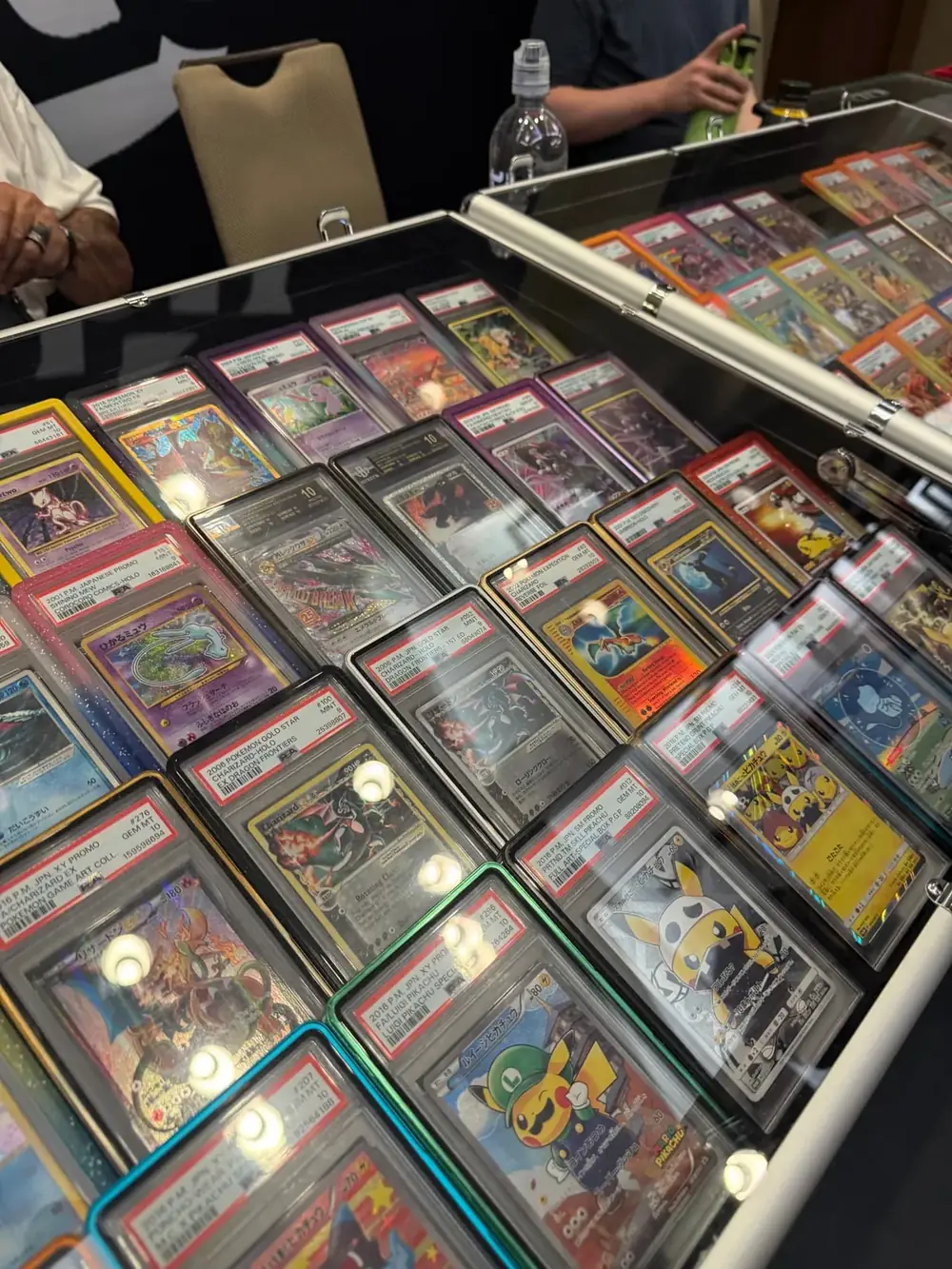 PSA graded Pokémon slabs at The Cactus TCG Show Display case packed with PSA graded vintage Charizard, Pikachu and Mew Pokémon slabs at The Cactus TCG Show in Mesa, Arizona